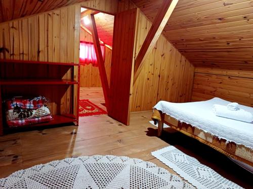 a bedroom with a bed in a wooden room at Casa Canto Verde in Visconde De Maua