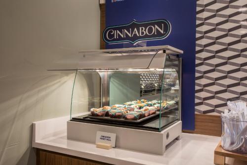 a display of donuts in a glass display case at Holiday Inn Express & Suites - Rock Hill by IHG in Rock Hill
