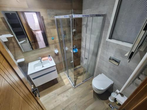 a bathroom with a shower and a toilet and a sink at la fontaine in Nabeul