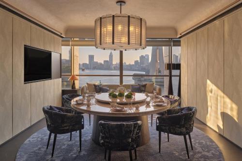 a dining room with a table and chairs and a large window at Regent Shanghai on the Bund in Shanghai