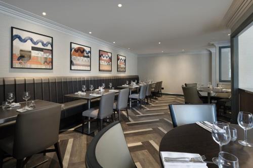 a dining room with tables and chairs with wine glasses at Edinburgh Marriott Hotel Holyrood in Edinburgh