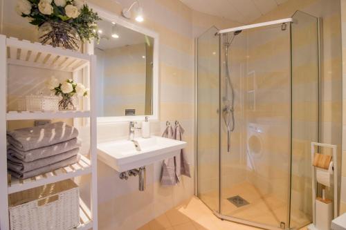 a bathroom with a sink and a shower at City Center Luxury Apartment in Tartu