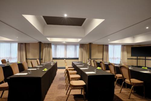 a conference room with long tables and chairs at Edinburgh Marriott Hotel Holyrood in Edinburgh