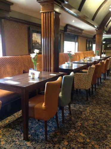 a row of tables and chairs in a restaurant at Ballymac Hotel in Stonyford