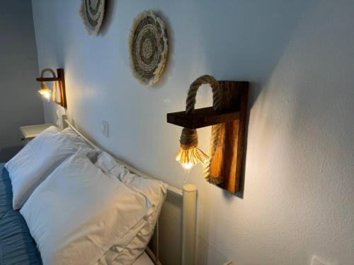 a bedroom with a bed and a shelf on the wall at The 3 Little Pigs apartments in Sidari