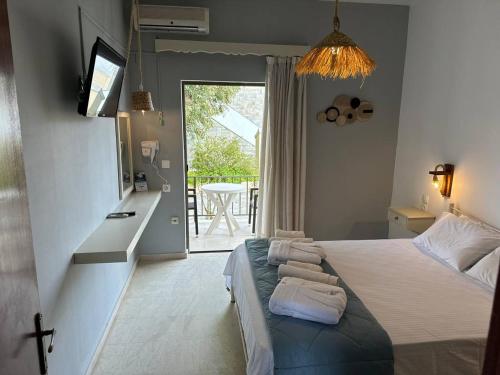 a bedroom with a bed with towels on it at The 3 Little Pigs apartments in Sidari