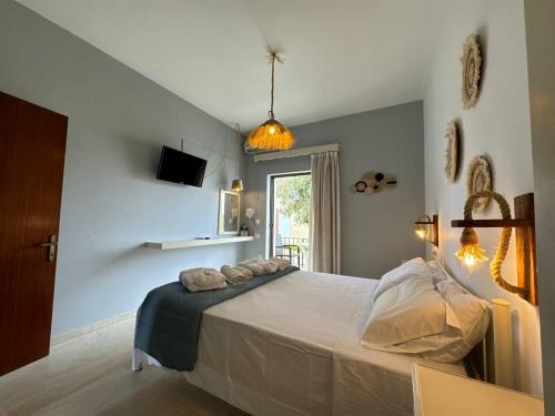 a bedroom with a large bed in a room at The 3 Little Pigs apartments in Sidari