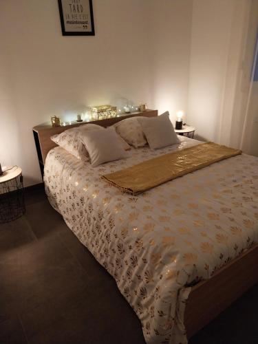 a bedroom with a large bed with lights on it at Location en nuitée in Abeilhan