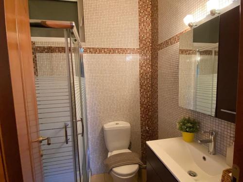 a bathroom with a toilet and a sink and a shower at Pool Garden House near the Sea in Vari