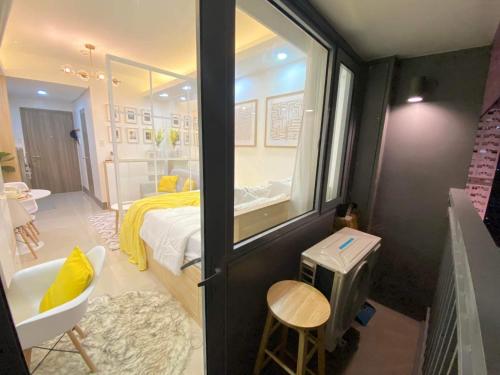 a room with a bedroom with a bed and a window at 1BR w/ Balcony near Megamall: The Admiral‘s Lounge in Manila