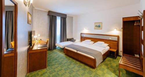 a hotel room with two beds and a television at Best Western Airport Hotel Stella in Zagreb