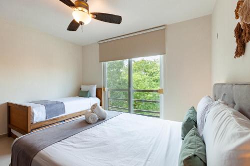 a bedroom with two beds and a window at Via Tendenza Condos in Playa del Carmen
