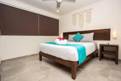 a bedroom with a large bed and a table at Suite de lujo 1 Hab. Depto 203 in Playa del Carmen