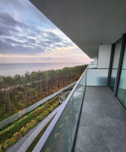 a view of the ocean from the balcony of a building at Apartament Mięta in Międzyzdroje