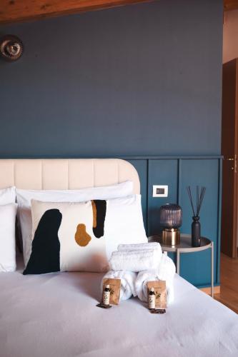 a bedroom with a bed with a blue wall at PENTHOUSE CON VISTA [6 minuti dal Bernina Express] in Tirano