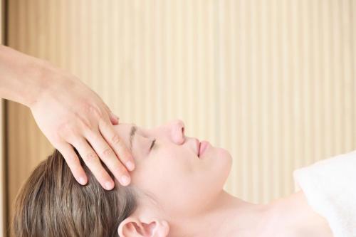 a woman getting her face examined by a dermatologist at HOTEL THE MITSUI KYOTO, a Luxury Collection Hotel & Spa in Kyoto
