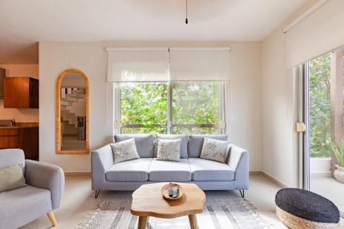 a living room with a couch and a table at Via Tendenza Condos in Playa del Carmen