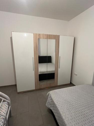 een slaapkamer met een bed en een kast met een spiegel bij Ferienwohnung Louis in Gerolstein