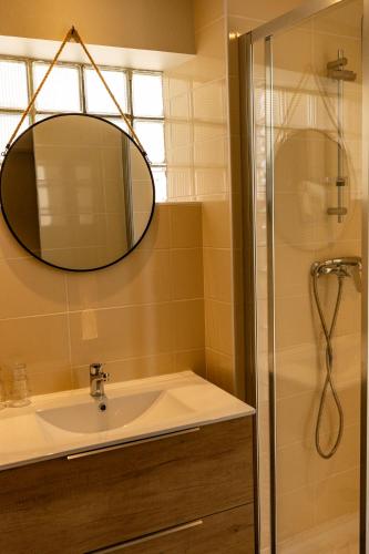 a bathroom with a sink and a shower at Hôtel Le Coq d'Or in Les Angles