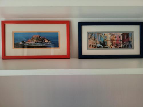 three framed pictures hanging on a wall at Apartment Andjela in Belgrade