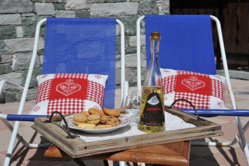 a table with a bottle of wine and a plate of food at L'Ancien Paquier Chambre D'Hotes in Valtournenche