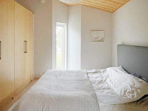 a white bed in a room with a window at 4 star holiday home in Klintehamn-By Traum in Klintehamn
