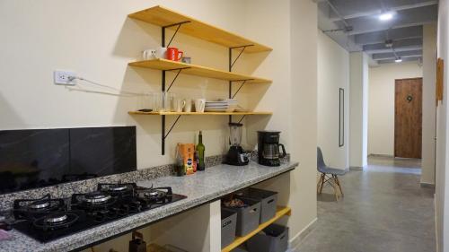 a kitchen with a stove and a counter top at Selva House in Medellín