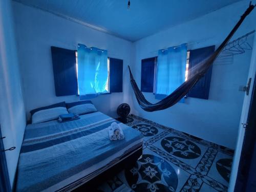 a bedroom with a bed with a hammock in it at Canto da Sereia. in Soure