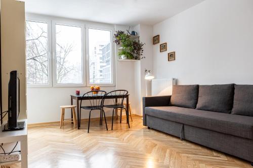 a living room with a couch and a table at Book a book - Apartment in the city center in Warsaw