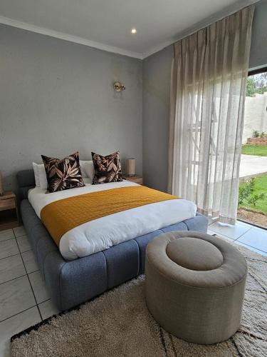 a bedroom with a large bed with a large window at Lanina Self Catering Apartments in Johannesburg
