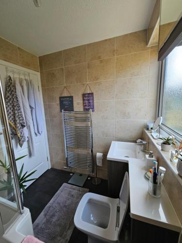 a small bathroom with a sink and a toilet at Iris Stay in Edinburgh