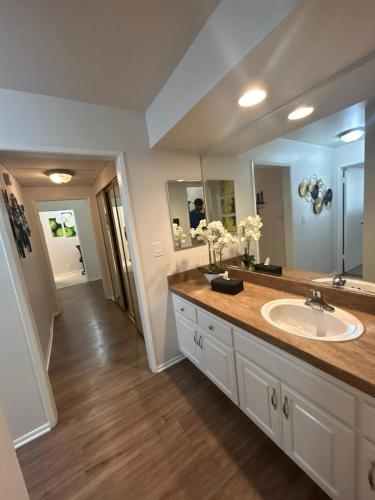 a bathroom with a sink and a large mirror at Beverly Hills City Vibe 1 br Apt w Parking 324 in Los Angeles