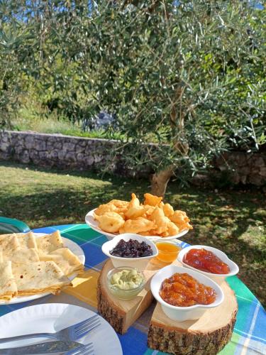 a table with different types of food on it at Sailor's Rustic House in Virpazar