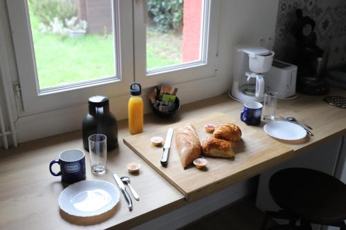 a table with croissants and pastries on it at Le Fort Vauban in Ambleteuse