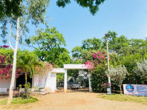 einen Eingang zu einem Gebäude mit rosa Blumen in der Unterkunft HOSTAL OLAS CLUB DE NEGUANJE -TAYRONA in Santa Marta