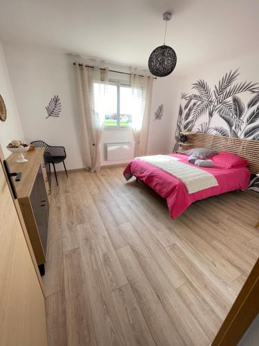 a bedroom with a bed and a wooden floor at Gîte du blé normand in Corny