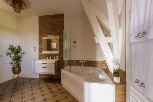 une salle de bain blanche avec une baignoire et un lavabo dans l'établissement Le Marquisat gîte de charme en Minervois, à Olonzac