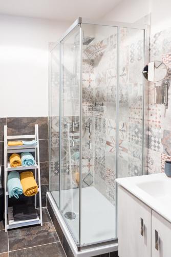 a shower with a glass door in a bathroom at B&B viktoria city house in Castrovillari