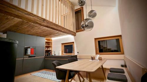 a kitchen with a wooden table in a room at Walliser Stadel in Fieschertal