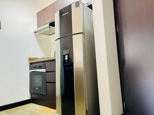 a large stainless steel refrigerator in a kitchen at Suite hotelera rio verde cerca al aeropuerto in Rionegro
