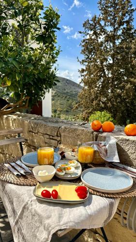 a table with plates of food on top at Anerada Cottages in Apsiou