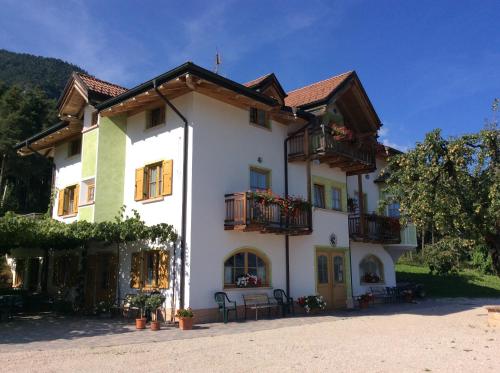 a large white building with balconies on it at Agriturismo Maso Tafol in Cloz