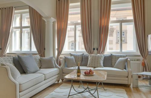 a living room with two couches and a table at Wishlist Prague Residences - Old Town Square in Prague