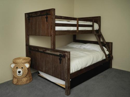 a bedroom with two bunk beds with a teddy bear at Cobalt Cabin Gateway to Grand Canyon Sedona & More in Williams