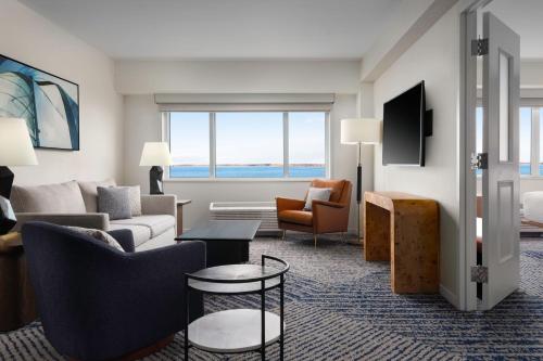 a living room with a couch and chairs and a table at Sheraton Erie Bayfront Hotel in Erie