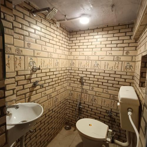 a bathroom with a white toilet and a sink at Feel Aesthetic Kashi Home Stay in Varanasi
