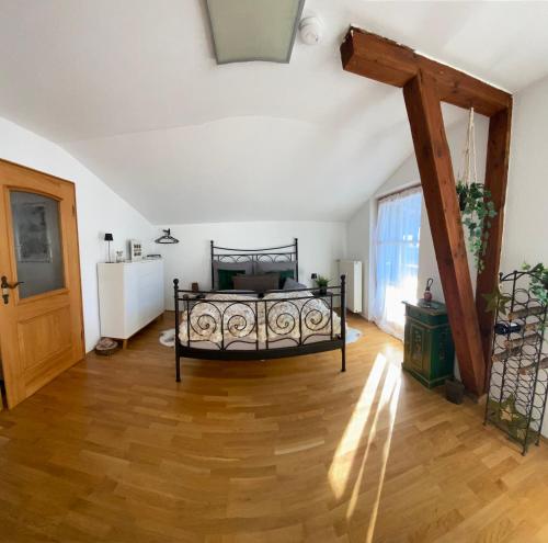 a bedroom with a bed and a wooden floor at NEUES ruhiges Apartment, Bergblick, Stellplatz in Bischofswiesen