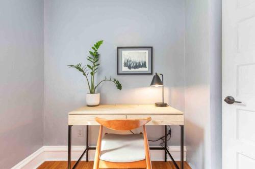 a desk with a potted plant and a lamp at Spacious Retreat with guest house, game room, parking in N Tacoma in Tacoma