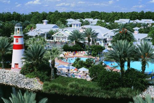 an aerial view of the resort with a pool and a lighthouse at Disney's Key West Resort Studio room sleeps 4 in Orlando