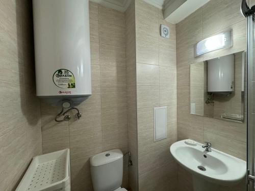 a small bathroom with a sink and a toilet at VIP Vision STUDIO 409 Sunny Beach in Sunny Beach